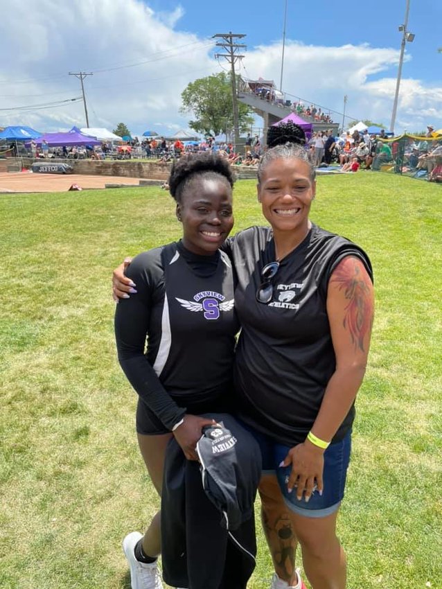 Bahati Nibandu, the state 4A girls shot put champion, and coach Jamila McCoy pose after the finals of the shot put at the state 4A track meet June 25.